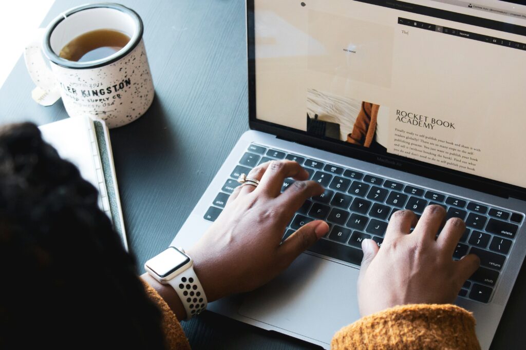 person on computer on squarespace create a portfolio website
