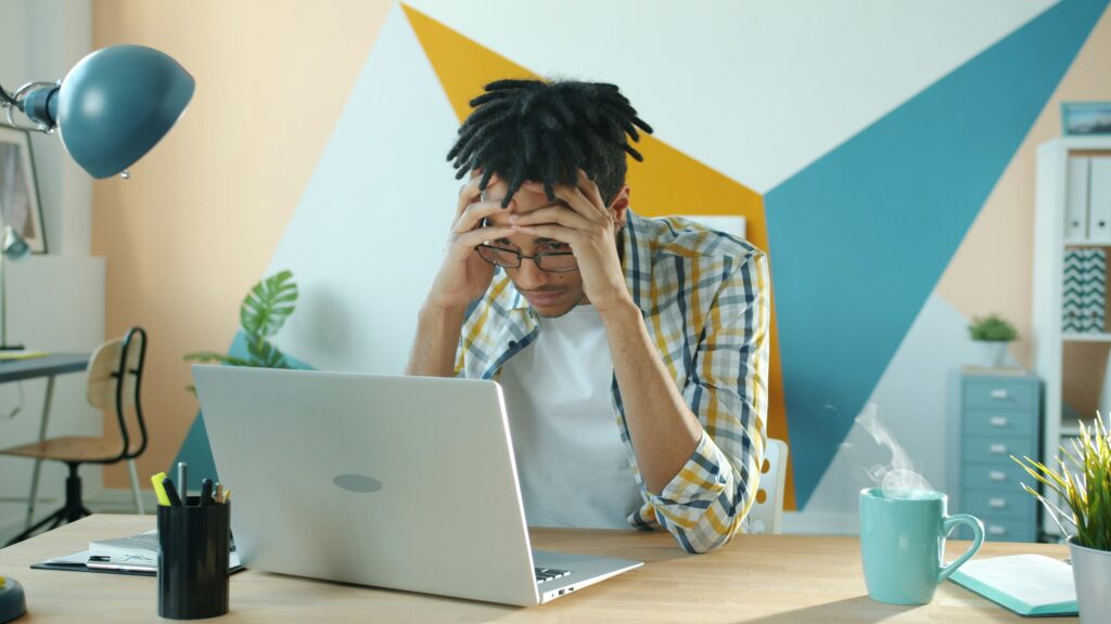 frustrated man on computer taxes for self-employed