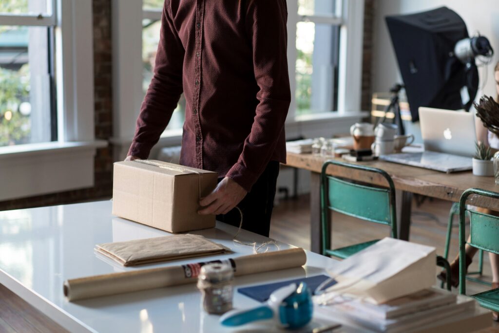 shipping station man packing a box set up a shipping station
