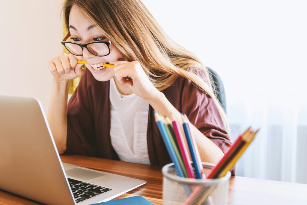 Woman working intensely at laptop stress stressed out upset school college