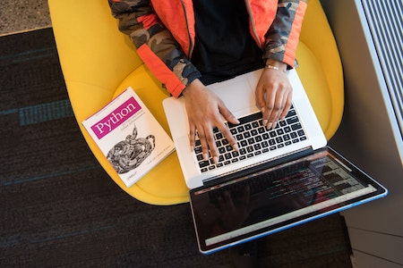 Woman Programming on a Notebook - professional training courses