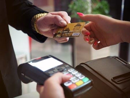 debt finance v equity finance person handing another person a credit card