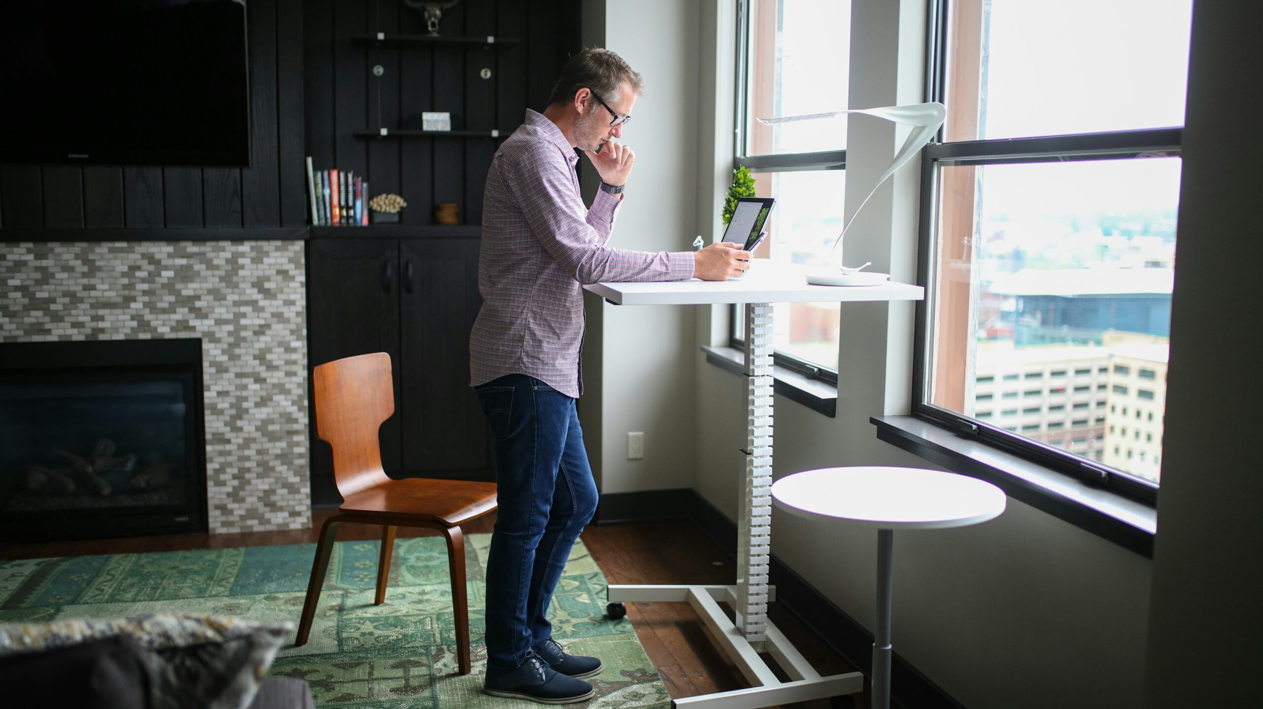 man working remote using standing desk remote hiring challenges