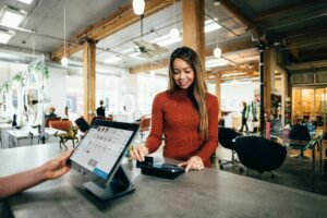 woman using credit card while shopping - credit utilization