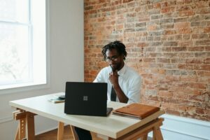 continuous compliance monitoring - man working on laptop
