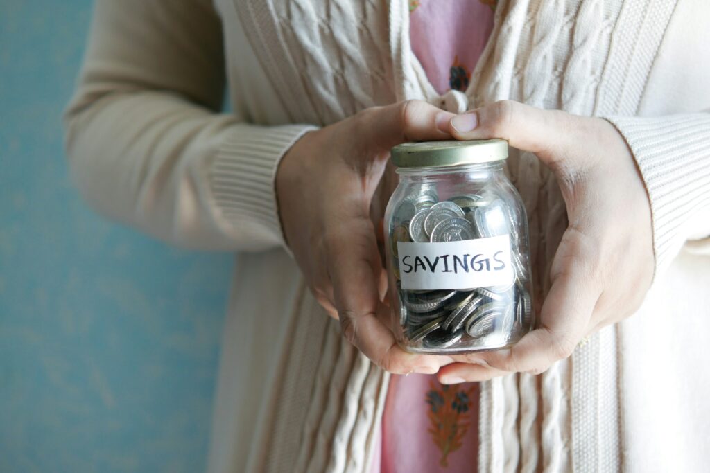woman holding money jar - best high yield savings account