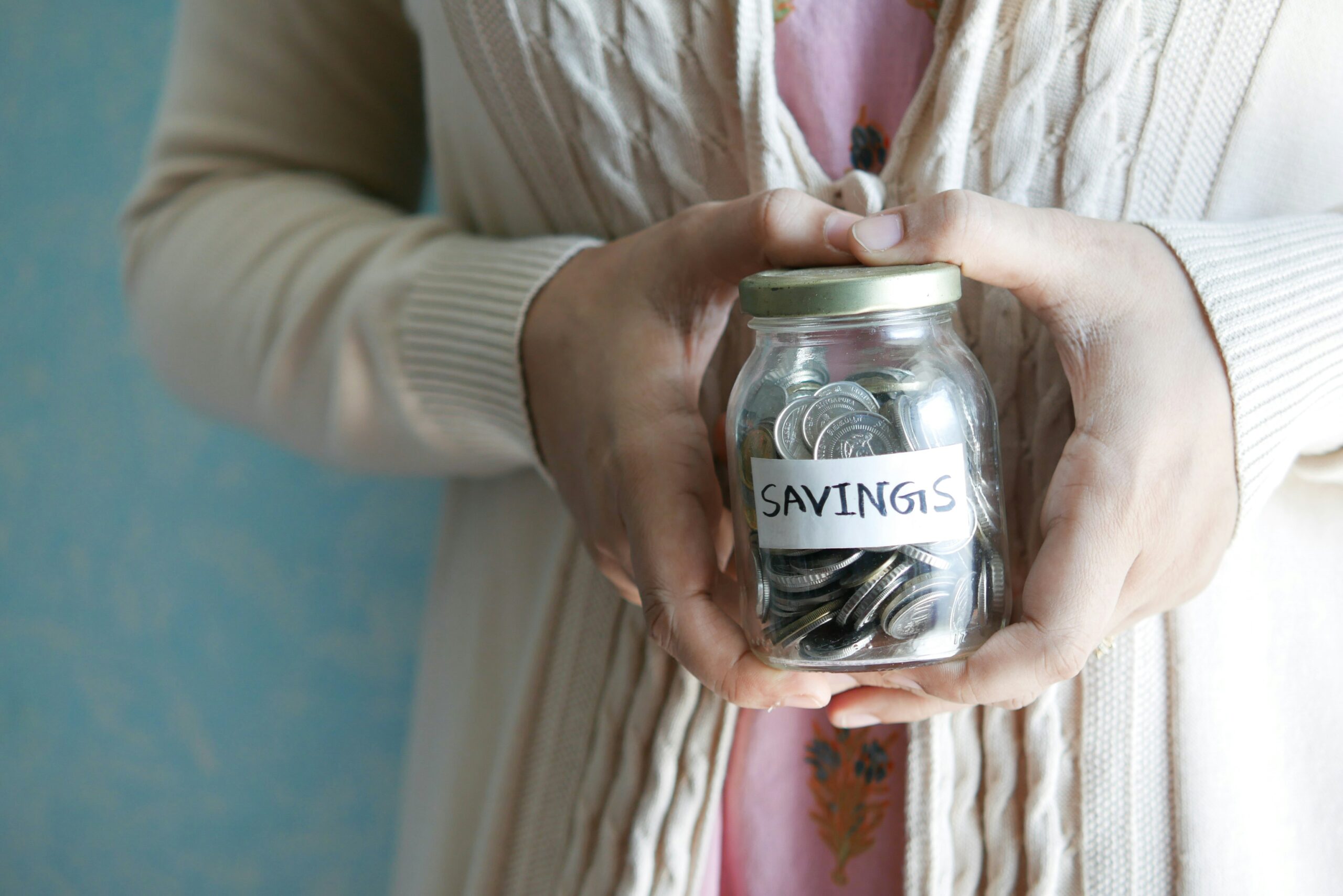 woman holding money jar - best high yield savings account