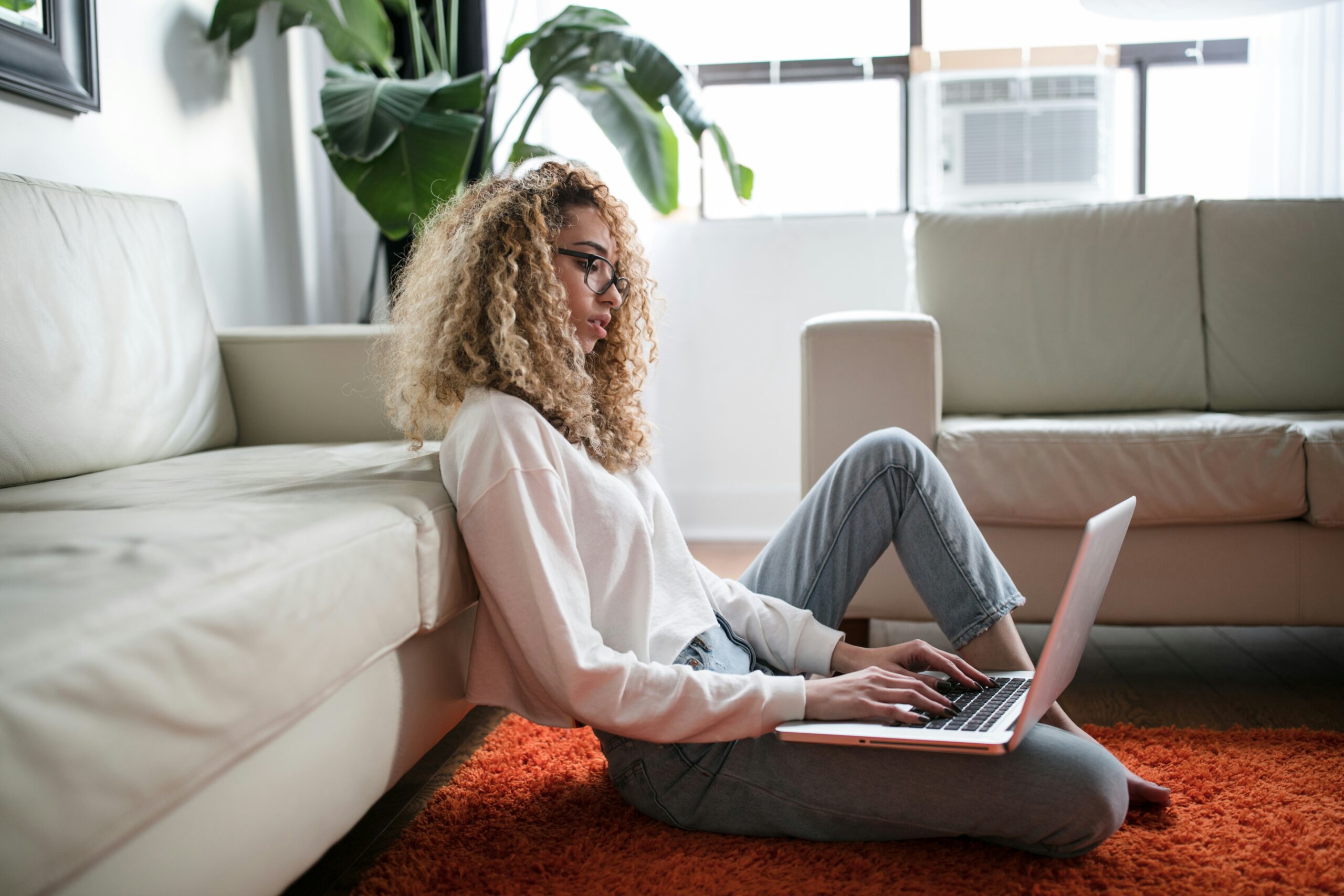 woman working on laptop - productive hybrid teams