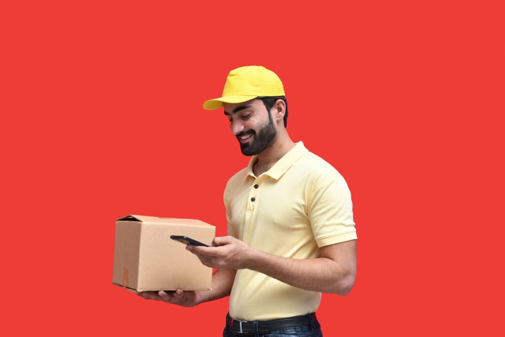 set up a shipping station man with packing materials holding box