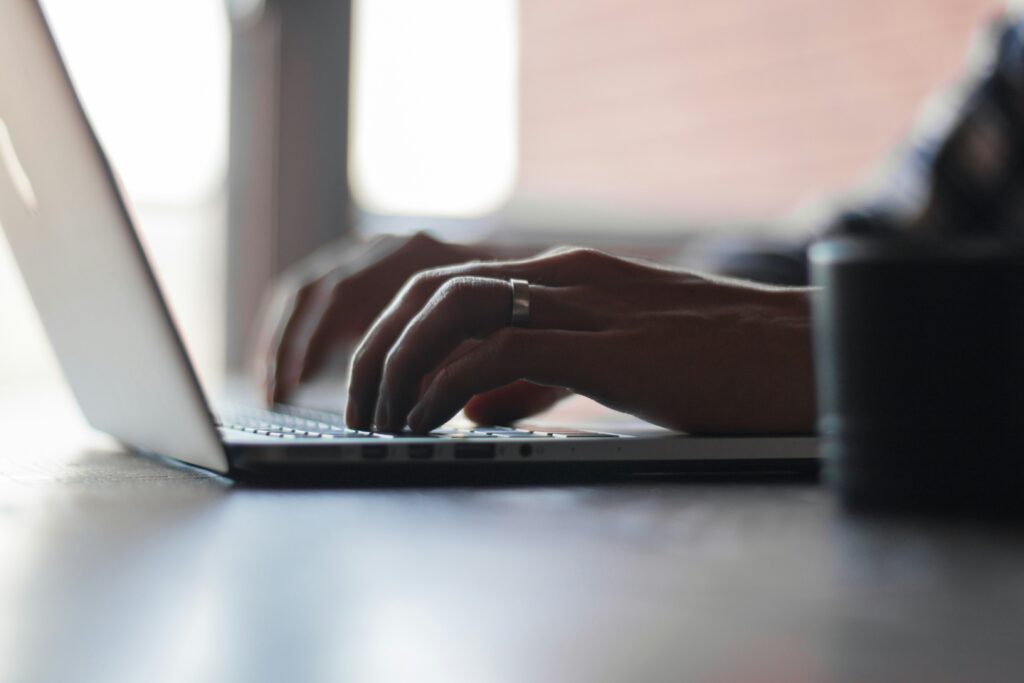person typing on computer laptop 
