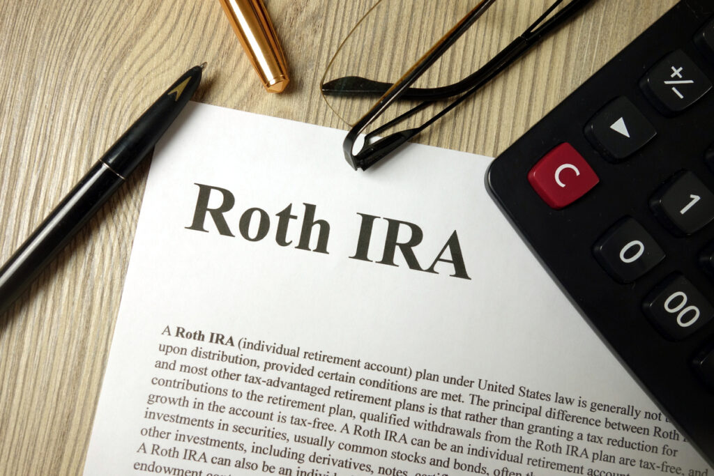 roth ira Roth IRA vs. Brokerage Account vs. Crypto Wallet Roth IRA mockup with calculator pen and glasses, retirement planning concept