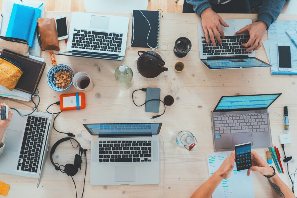 people working on laptops at work side hustles for professionals