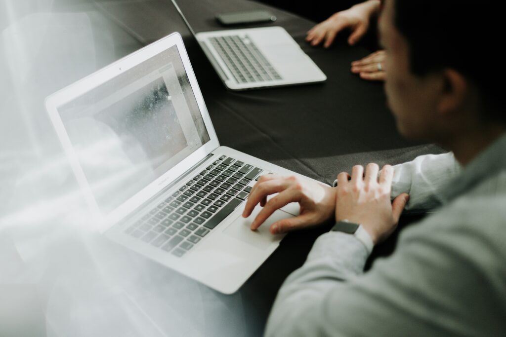 man on laptop working in meeting hybrid workspace strategy