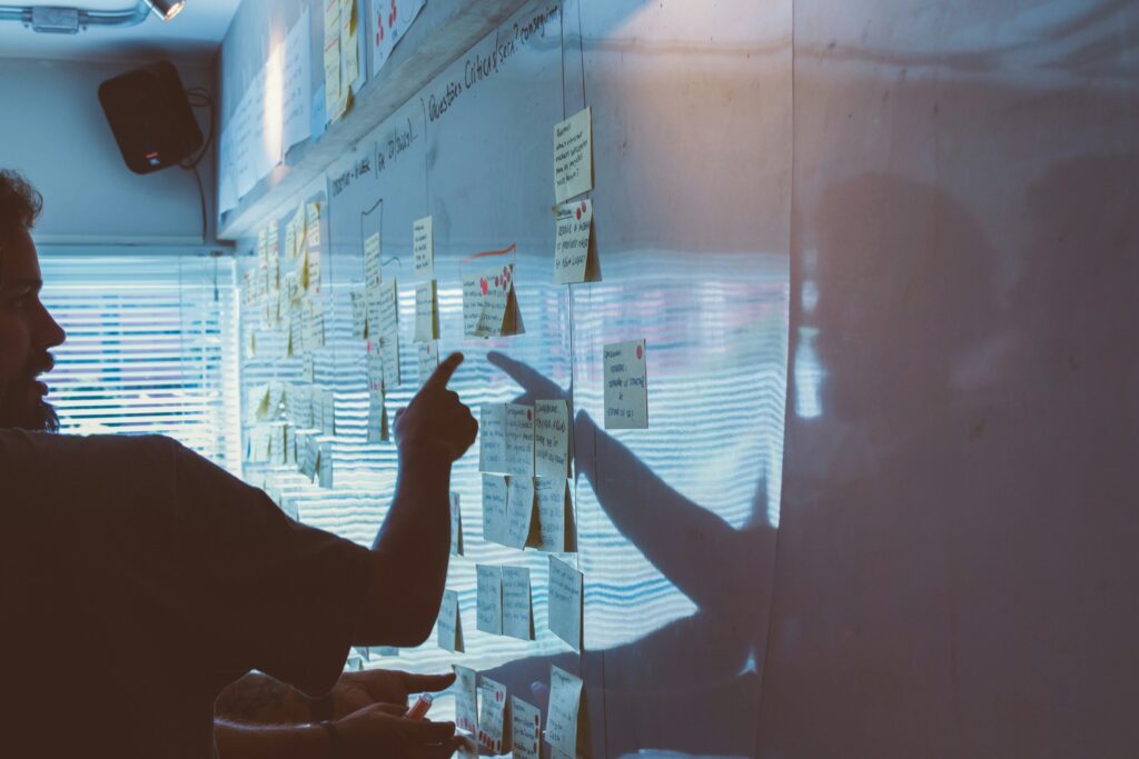 q4 business strategy planning planning meeting man pointing at whiteboard