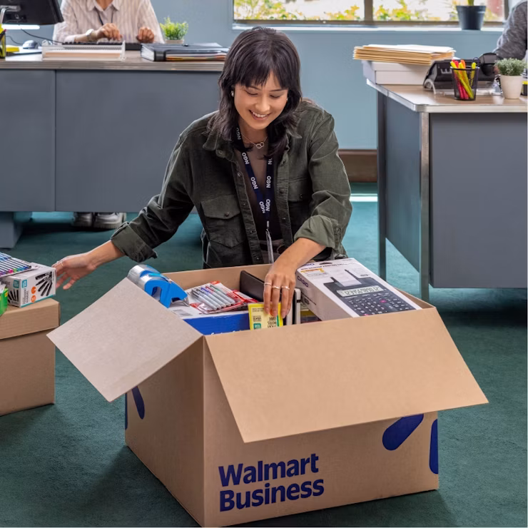 woman opening box of small business supplies for peak season