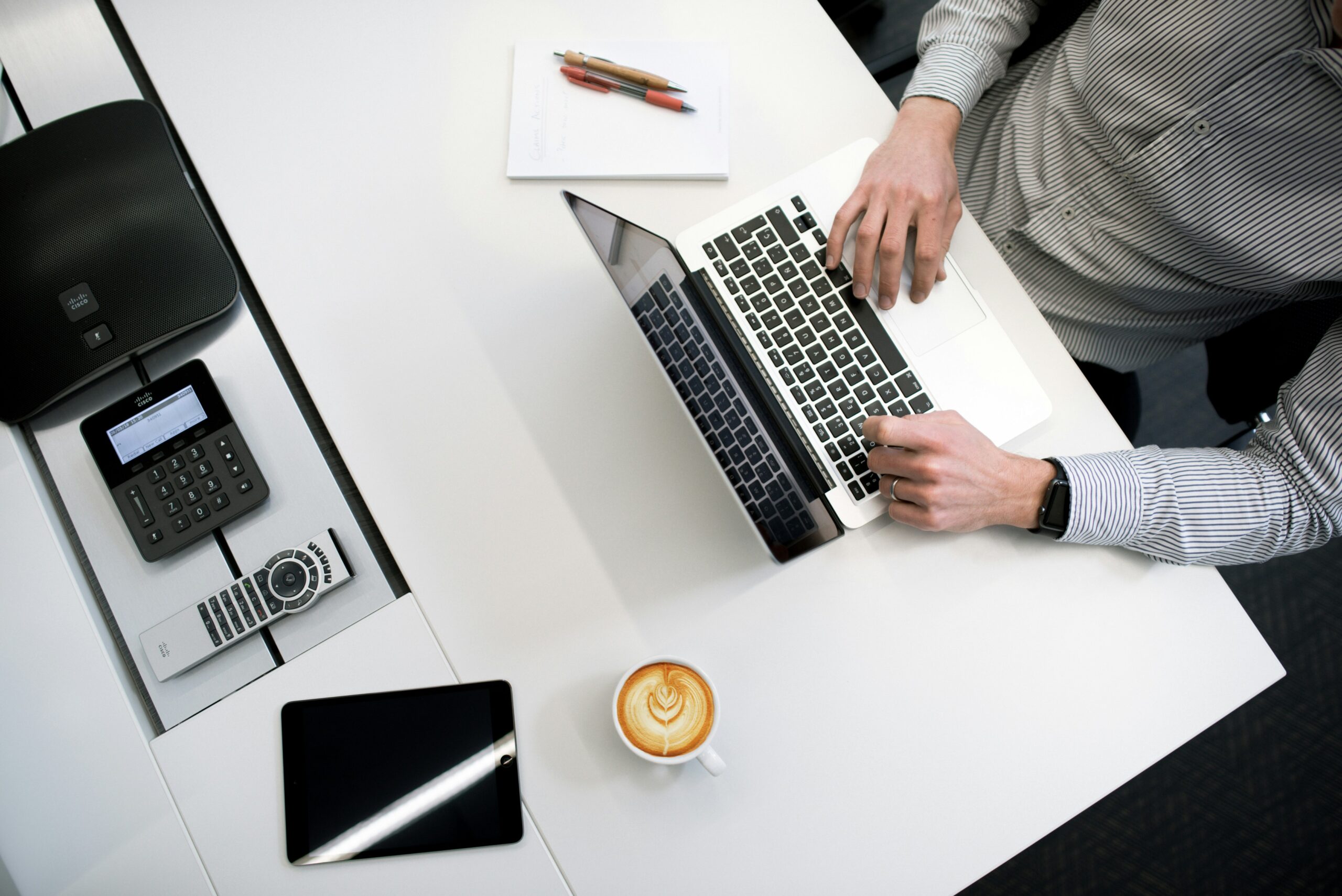 Person working on laptop at desk best crm for small business