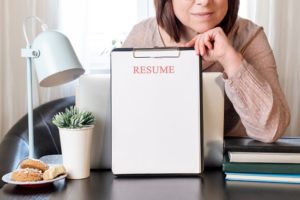 How to Write a Cover Letter woman resume with magnifier at the table. Cv resume concept. Finding a worker. Apply for a job. Business opportunity. Cv profile. how to update your resume for a job search