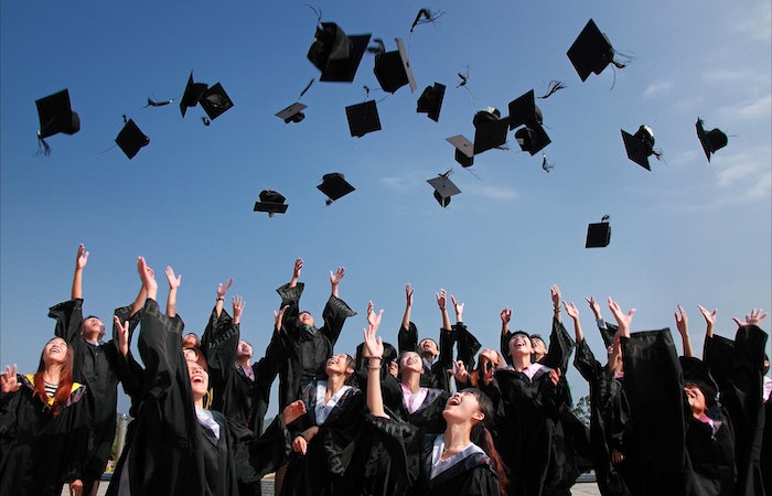 Newly Graduated People Wearing Black Academy Gown - Hire College Students