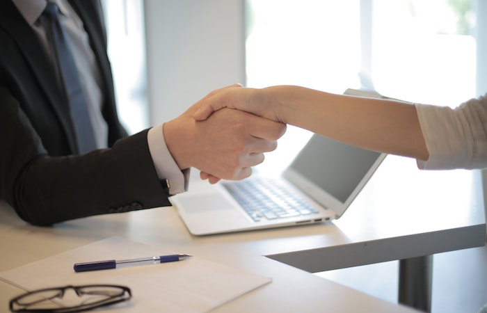 Person in Black Suit Hired An Employee - when to hire in your small business