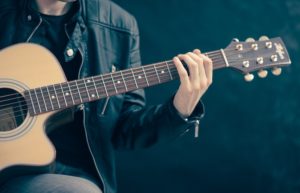 Person Holding Brown and Black Guitar - music industry resume template