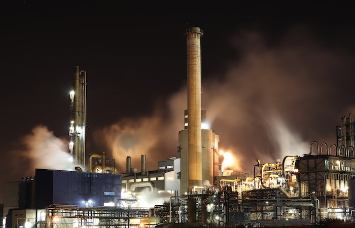 Brown and White Factory Building during Night Time - best paying jobs in basic industries