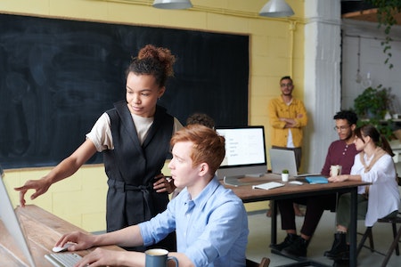 Photo Of Woman Pointing On Computer - technical project manager salary