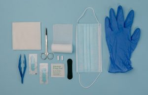 A Set of First Aid Kit Tools on Blue Surface - how to make a first aid kit for your car