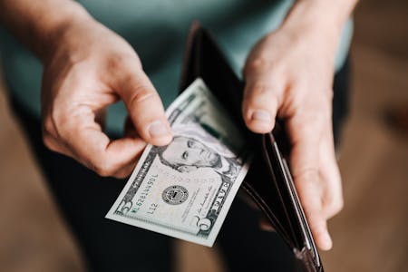 outsourced bookkeeping man with money in his hands
