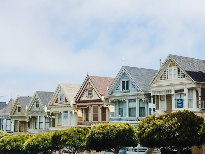 how to invest in real estate during high interest periods featured image with houses