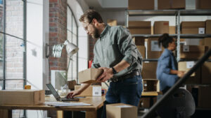 set up a shipping station Busy Day at Warehouse. Multicultural Employees at Work in Retail Shop's Storeroom. Small Business Owners Working on Laptop, Preparing and Packing Parcels for Delivery. create a portfolio website