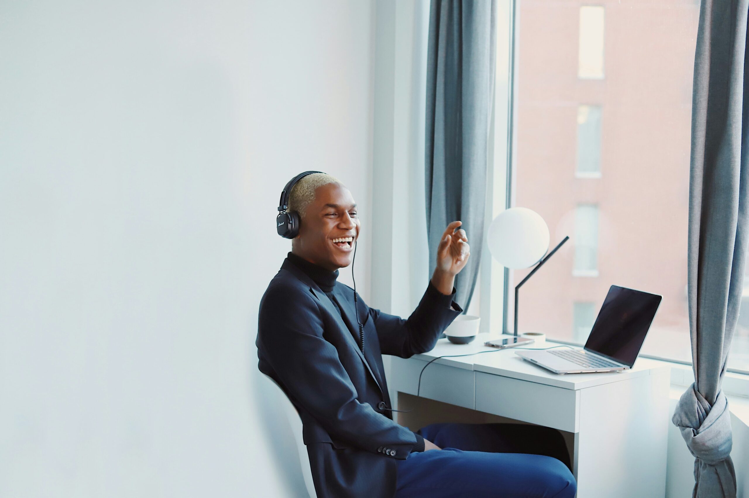 man smiling while on laptop how to attract top talent