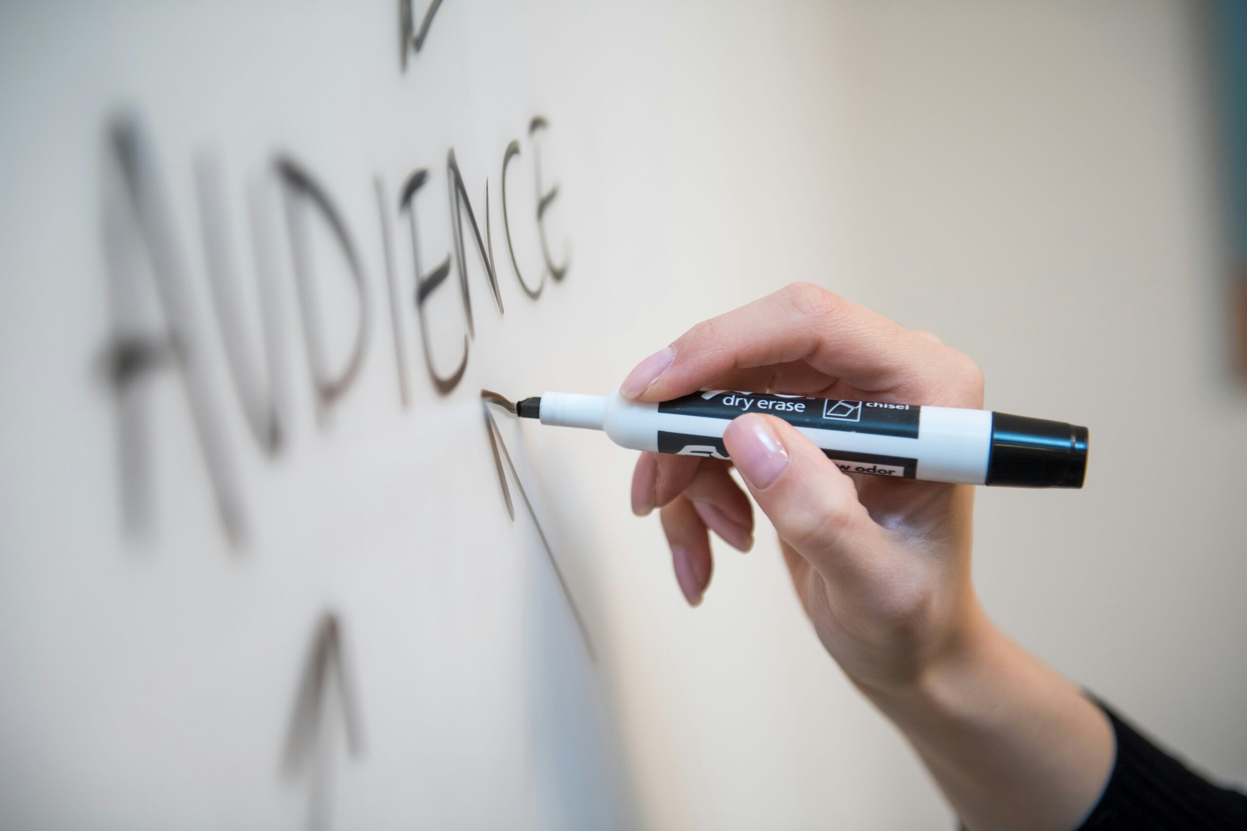 person writing audience on board what is a brand ambassador