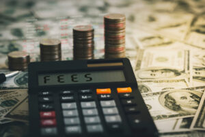 Calculator with the word FEES on the calculator placed on the dollar, concepts, fees, fees services and taxes. Best High Interest Savings Account