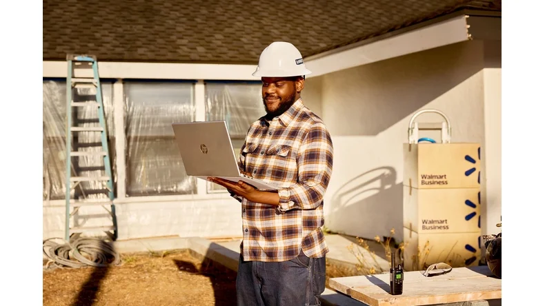 man on computer in construction zone